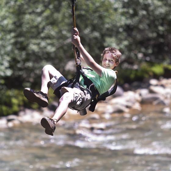 Young Soaring guest enjoys zip line across Animas